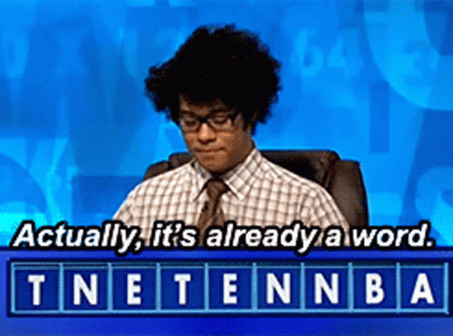 A Man Sitting In A Chair With The Words " Actually It 'S Already A Word " Above Him GIF