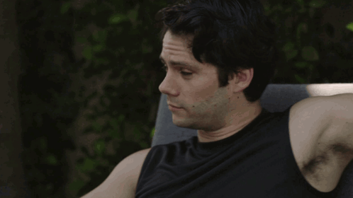 A Man Sitting In A Chair With The Words " I 'M Listening " Behind Him GIF