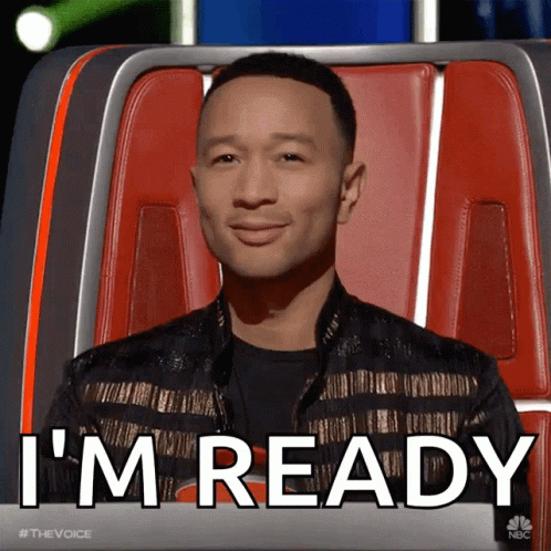 A Man Sitting In A Chair With The Words " I 'M Ready " On The Screen Behind Him GIF