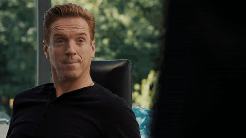 A Man Sitting In A Chair With The Words " I Need To See It " On The Bottom GIF