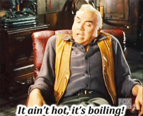 A Man Sitting In A Chair With The Words " It Ain 'T Hot It 'S Boiling " Above Him GIF