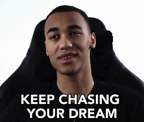 A Man Sitting In A Chair With The Words " Keep Chasing Your Dream " Written Below Him GIF