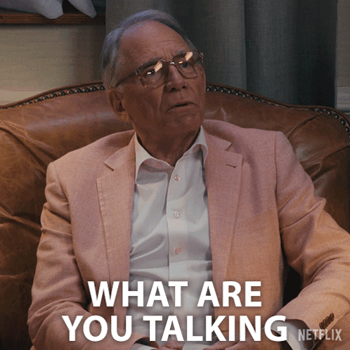 A Man Sitting In A Chair With The Words What Are You Talking Netflix Behind Him GIF