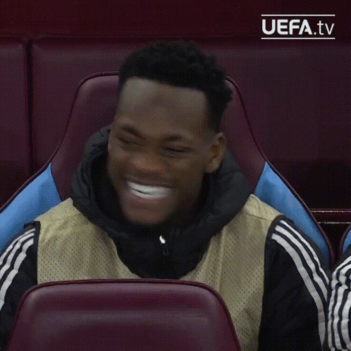 A Man Sitting In A Chair With Uefa.tv Written On The Bottom Right GIF