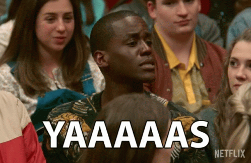 A Man Sitting In A Crowd With A Netflix Logo On The Bottom GIF