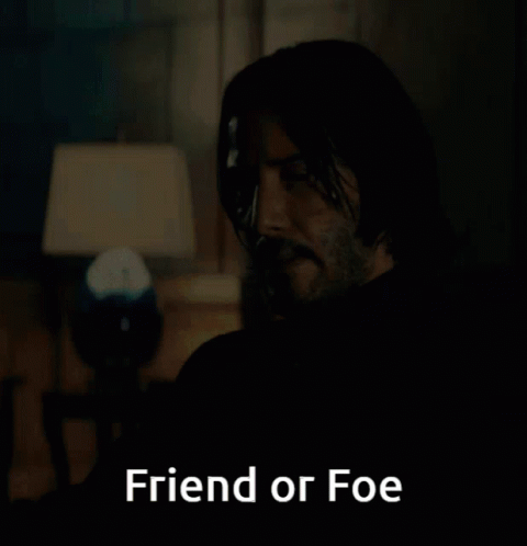 a man sitting in a dark room with the words friend or foe above him