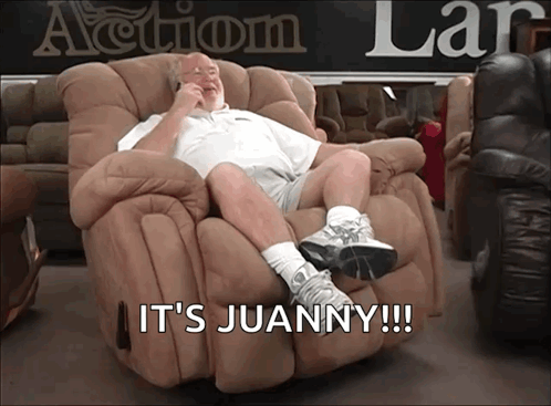 A Man Sitting In A Recliner With The Words It 'S Juanny Written Below Him GIF