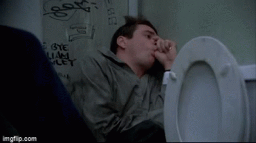 A Man Sitting In A Toilet With Graffiti On The Wall Behind Him That Says Bye And Let GIF