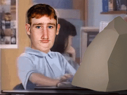 A Man Sitting In Front Of A Computer Monitor GIF