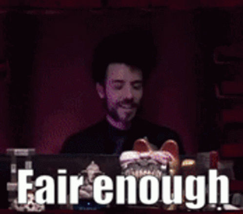 A Man Sitting In Front Of A Computer With The Words Fair Enough Written On The Screen Behind Him GIF