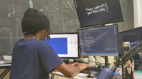A Man Sitting In Front Of A Computer With The Words If You 'Re Reading This You 'Ve Been Max Written On A Blackboard GIF