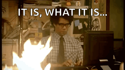 A Man Sitting In Front Of A Computer With The Words " It Is What It Is " On The Screen GIF