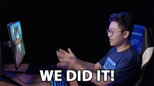 a man sitting in front of a computer with the words we did it written on the screen