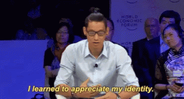 A Man Sitting In Front Of A Crowd With The Words " I Learned To Appreciate My Identity " GIF