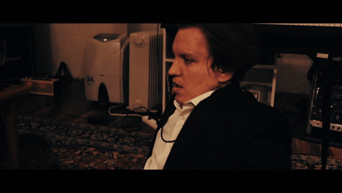 A Man Sitting In Front Of A Desk With The Word Monday On It GIF