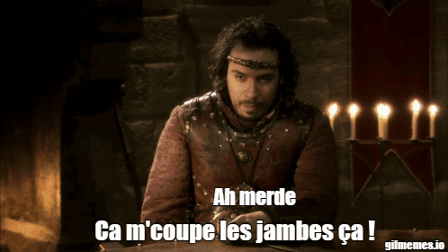 A Man Sitting In Front Of A Fireplace With The Words Ah Merde Ca M 'Coupe Les Jambes Ca GIF