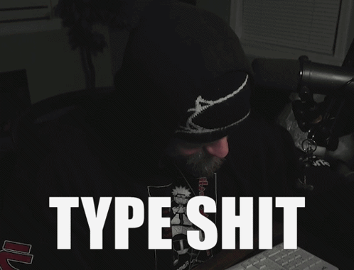 a man sitting in front of a keyboard with the words type shit written on the screen
