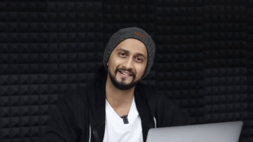 A Man Sitting In Front Of A Laptop With The Word Haha On The Bottom Right GIF