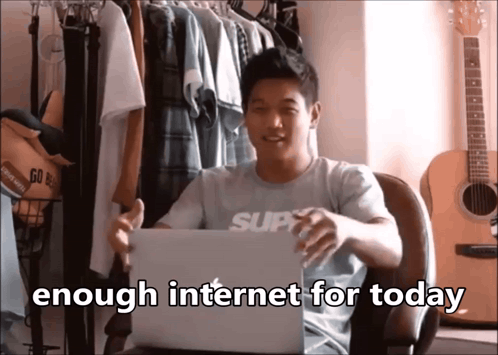 A Man Sitting In Front Of A Laptop With The Words " Enough Internet For Today " On The Bottom GIF
