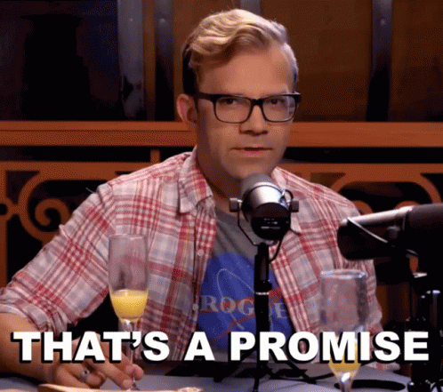 A Man Sitting In Front Of A Microphone Holding A Glass Of Champagne And Says That 'S A Promise GIF