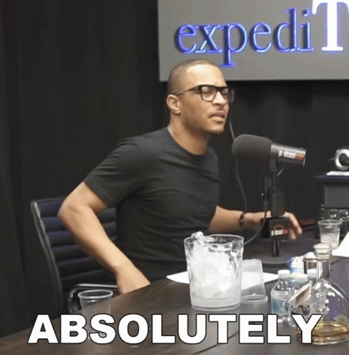 A Man Sitting In Front Of A Microphone With The Word Absolutely Written On The Bottom GIF