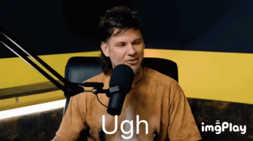 A Man Sitting In Front Of A Microphone With The Word Ugh Written On The Screen GIF