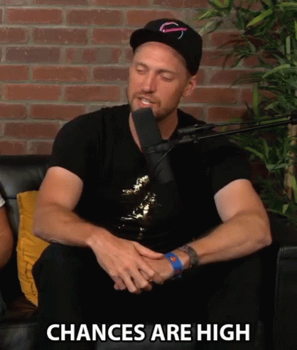 a man sitting in front of a microphone with the words " chances are high " written below him