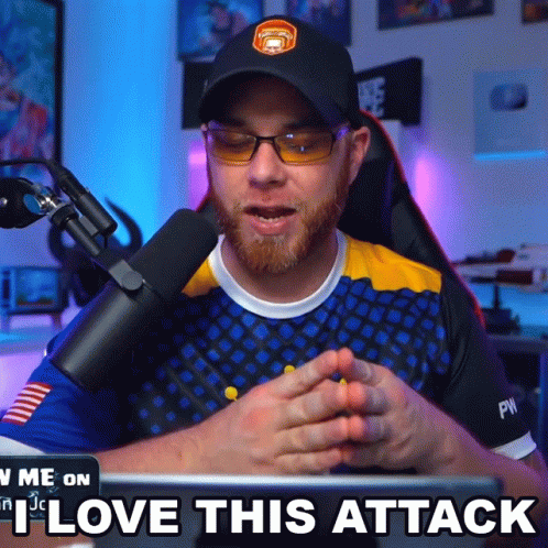 A Man Sitting In Front Of A Microphone With The Words " I Love This Attack " Below Him GIF