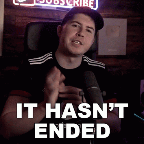 A Man Sitting In Front Of A Microphone With The Words " It Hasn 'T Ended " Below Him GIF