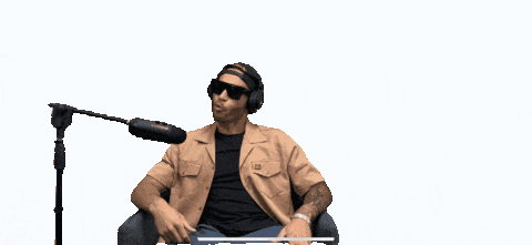 A Man Sitting In Front Of A Microphone With The Words " People Are Fucking Lazy " Above Him GIF