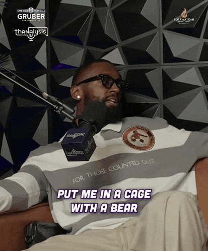 A Man Sitting In Front Of A Microphone With The Words Put Me In A Cage With A Bear On The Bottom GIF