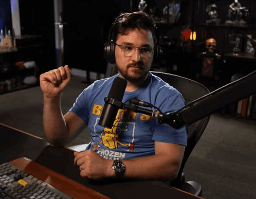 A Man Sitting In Front Of A Microphone With The Words Very Unimpressed Applause Written Below Him GIF