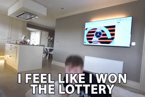 A Man Sitting In Front Of A Television With The Words " I Feel Like I Won The Lottery " Above Him GIF