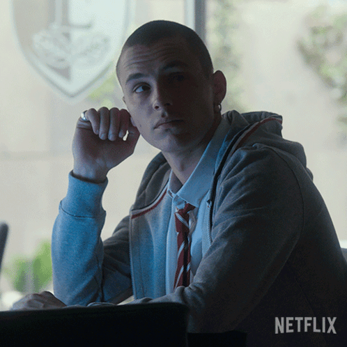 A Man Sitting In Front Of A Window With The Word Netflix On The Bottom GIF