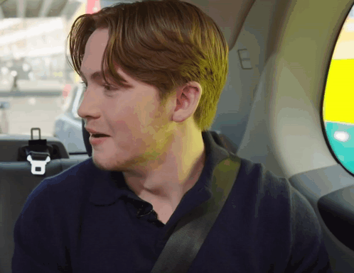 A Man Sitting In The Back Seat Of A Car GIF
