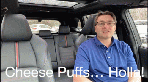 A Man Sitting In The Back Seat Of A Car Talking About Cheese Puffs Holla GIF