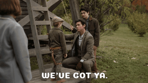 A Man Sitting On A Bench Talking To A Little Boy With The Words We 'Ve Got Ya Written On The Bottom GIF