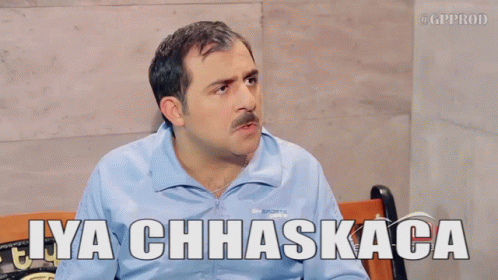 A Man Sitting On A Bench With The Words Iya Chhaskaca Above Him GIF