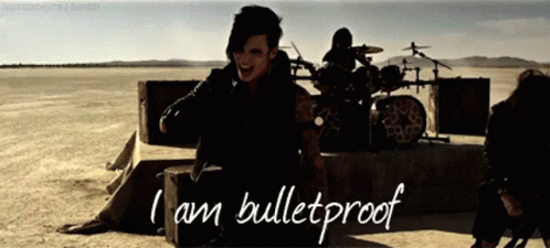 A Man Sitting On A Box With The Words I Am Bulletproof On The Bottom GIF