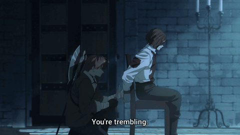 A Man Sitting On A Chair Talking To Another Man With The Words You 'Re Trembling Below Him GIF