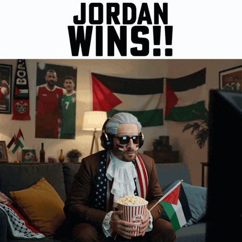 A Man Sitting On A Couch Holding A Popcorn Bucket With The Words Jordan Wins Below Him GIF