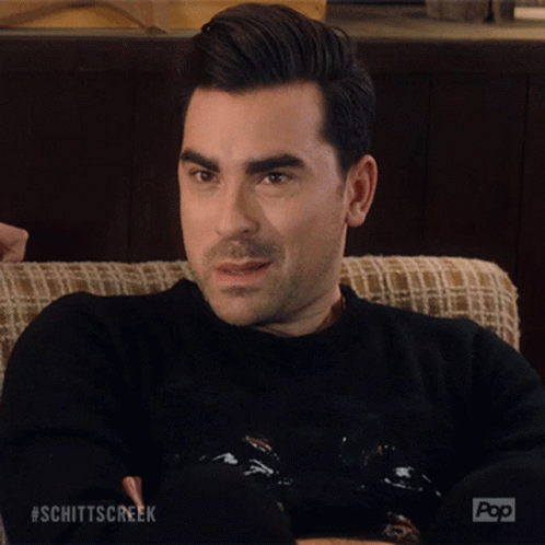 A Man Sitting On A Couch With His Eyes Closed And The Word Okay Written On His Face GIF