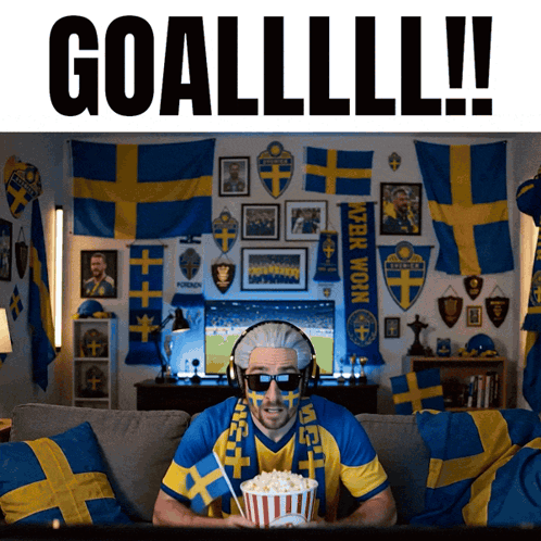 A Man Sitting On A Couch With Popcorn And A Scarf That Says ' Sven ' On It GIF