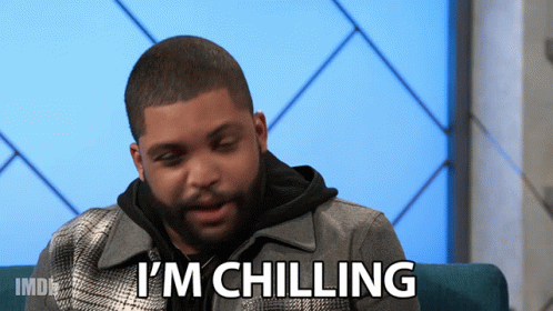 A Man Sitting On A Couch With The Words " I 'M Chilling " Above Him GIF