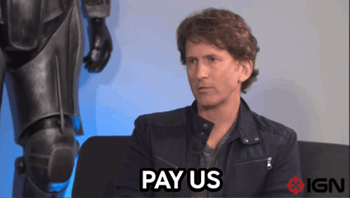 A Man Sitting On A Couch With The Words Pay Us Above Him GIF