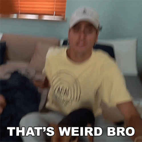 A Man Sitting On A Couch With The Words That 'S Weird Bro Written Below Him GIF