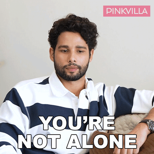 A Man Sitting On A Couch With The Words You 'Re Not Alone On The Bottom GIF