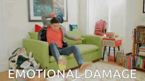 A Man Sitting On A Green Couch With The Words Emotional Damage Written On The Bottom GIF