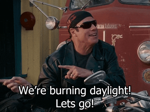 A Man Sitting On A Motorcycle Says " We 'Re Burning Daylight Lets Go " GIF