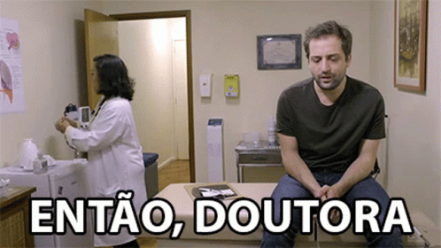 A Man Sitting On A Table With The Words Entao Doutora Written Above Him GIF